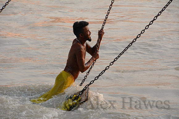 Pilgrim at morning aarti ceremony on Ganges River, Haridwar, Uttarakhand, India